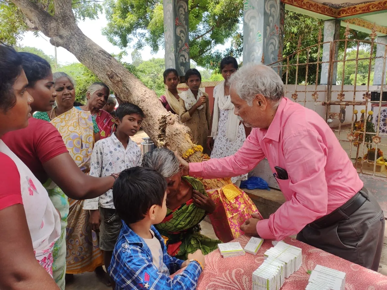 A family at a free village Ayurveda camp near Uthiramerur